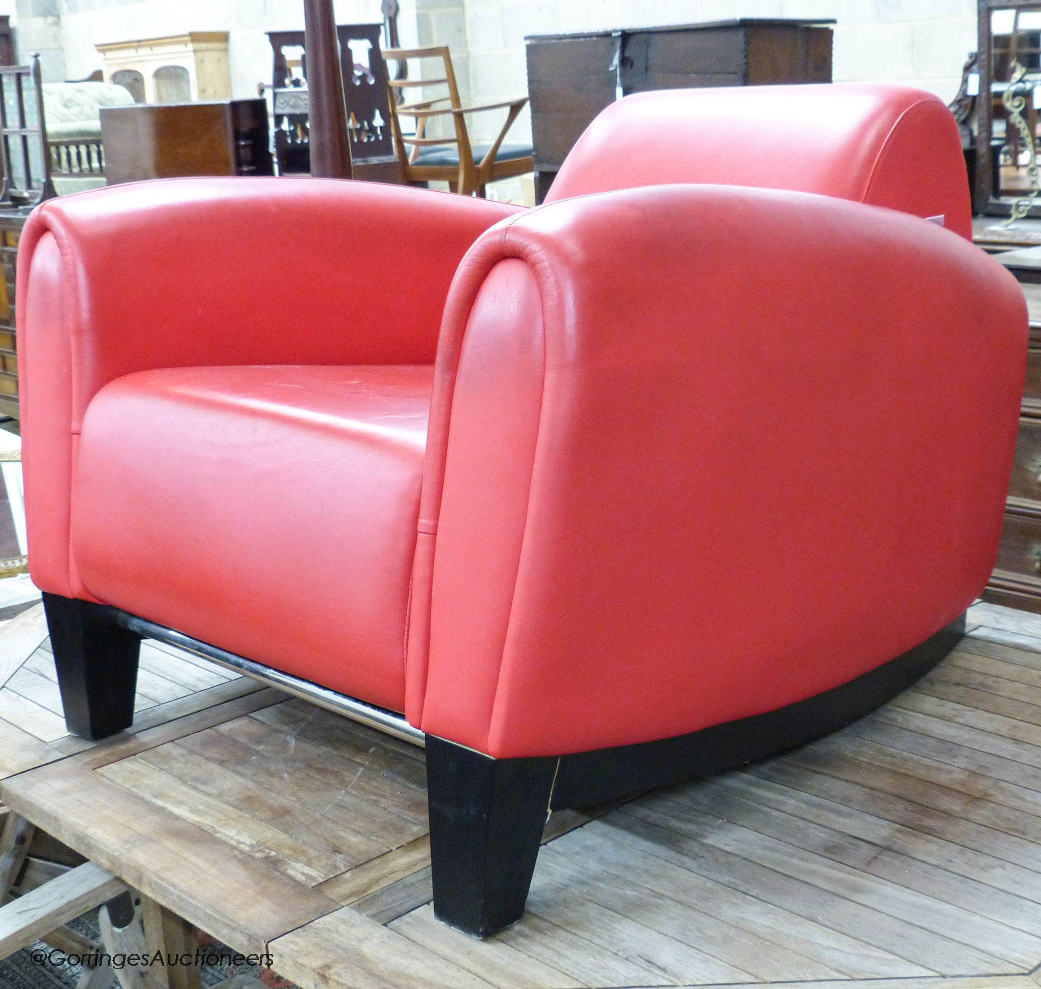 A red leather club armchair, height 70cm, width 87cm, depth 98cm